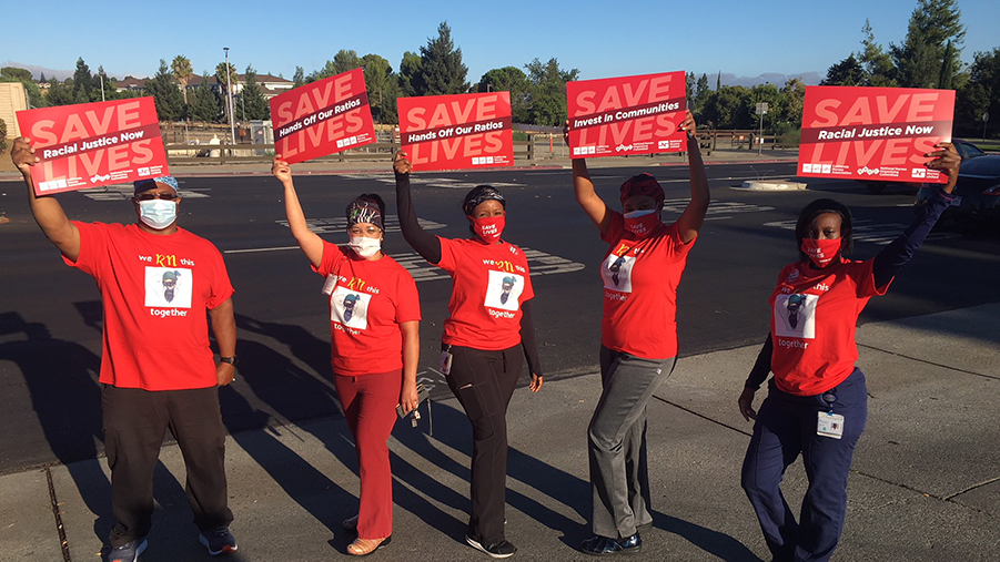 Nurses hold signs "Black Lives Matter"