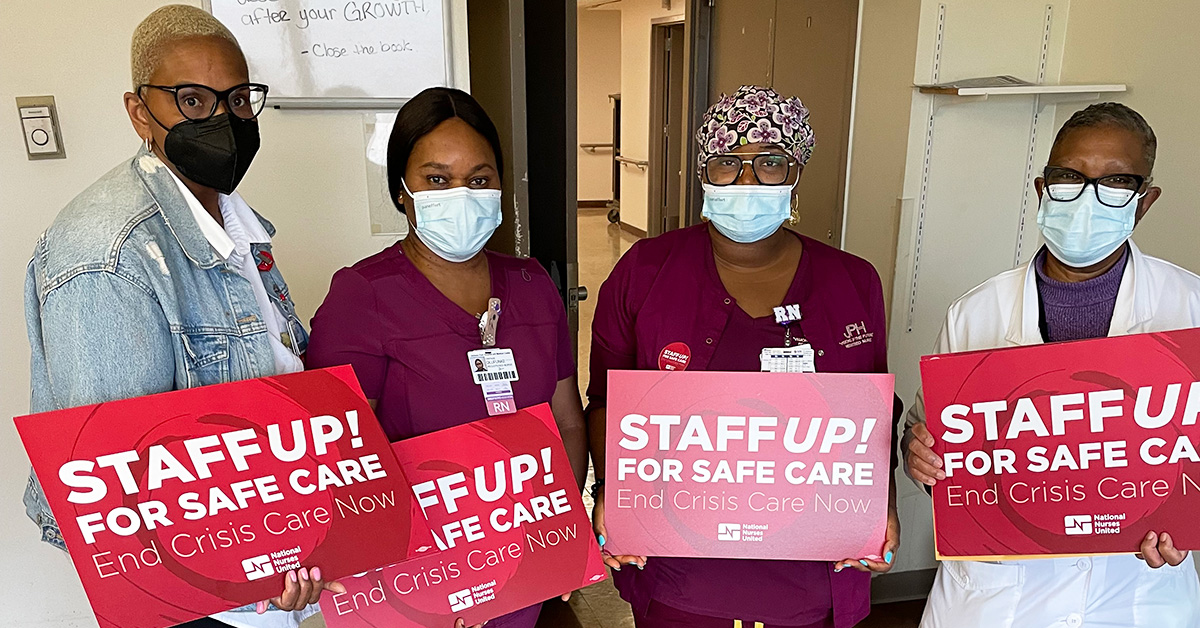 Nurses at Jackson Park Hospital hold signs that read "Staff up for safe care!"