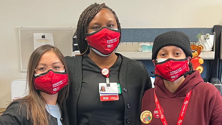Three nurses wearing masks that read "Staff up for safe care"
