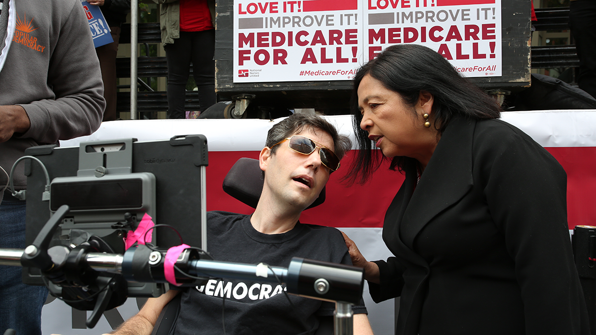 Ady barkan talking to NNU Executive Director Bonnie Castillo and Medicare for All event