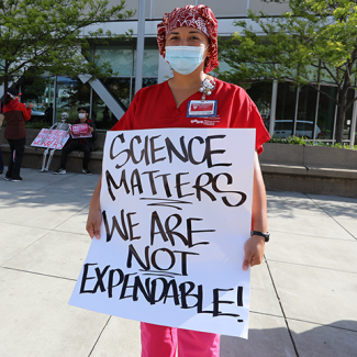 Nurses outside with sign "Science matters we are not expendable"