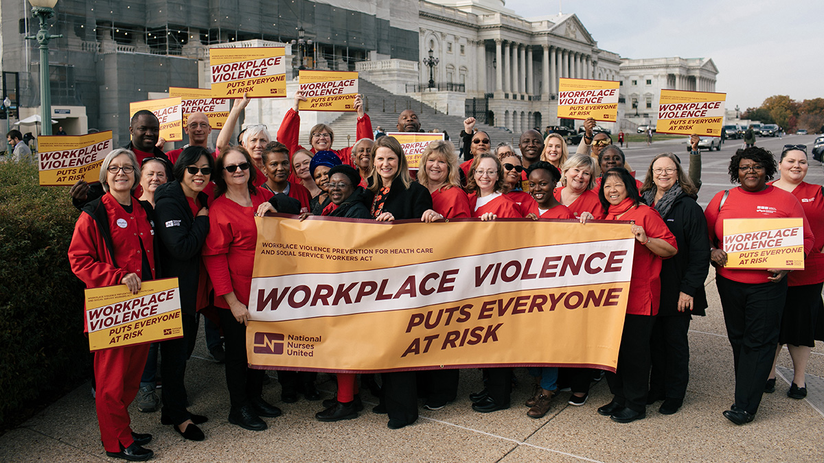 Nurses outside Capitol building hold signs in support of safe hospitals