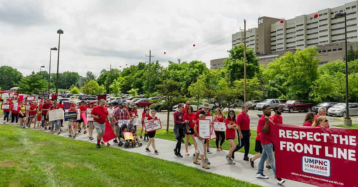 Long line of nurses holding march