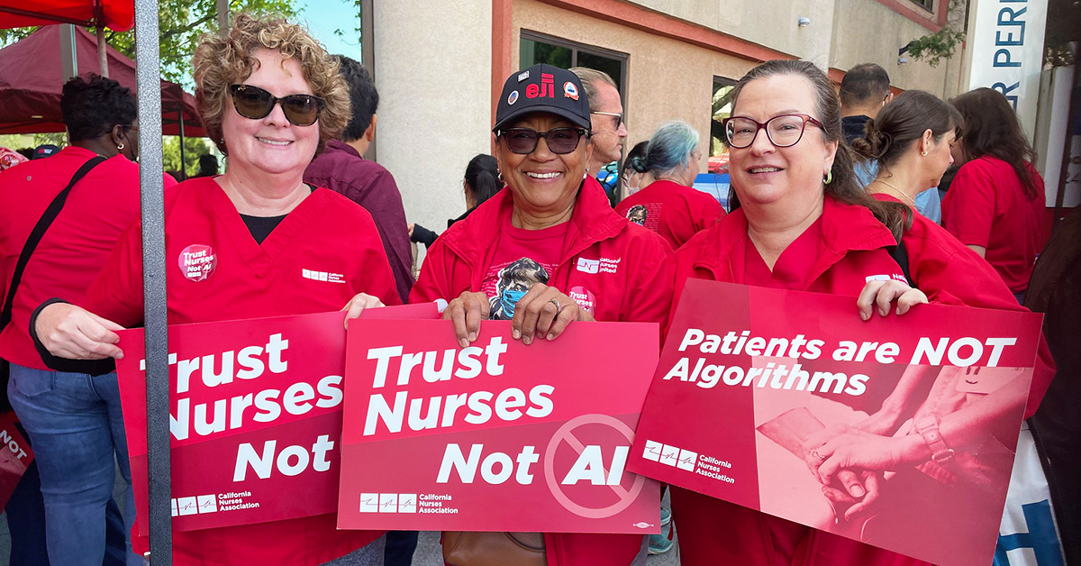 Three nurses hold signs "Trust Nurses, Not A.I."