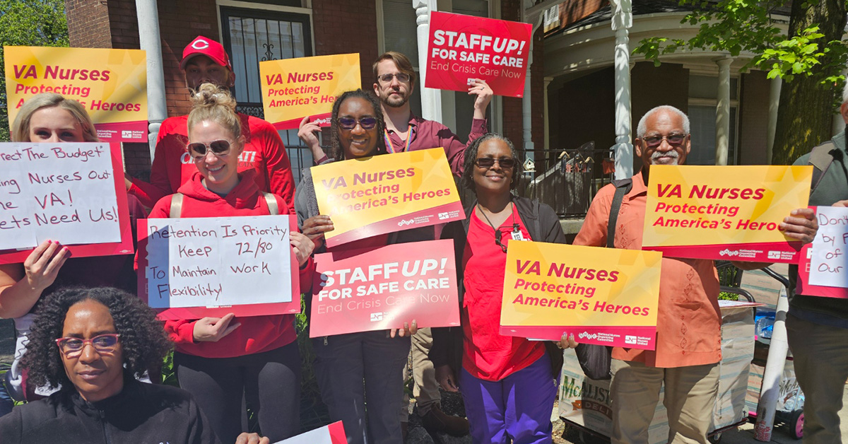 Nurses outside holding signs "VA Nurses: Protecting America's Heroes"