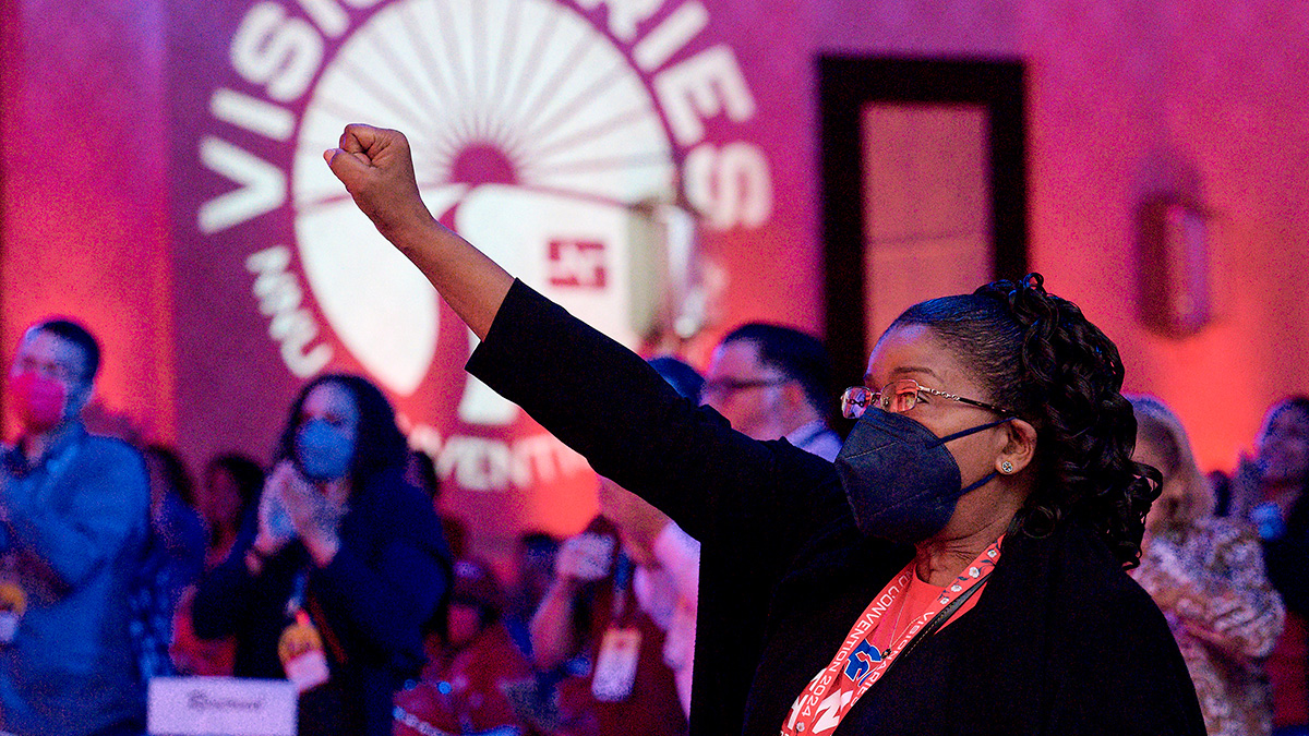 Nurse inside convention with raised fist