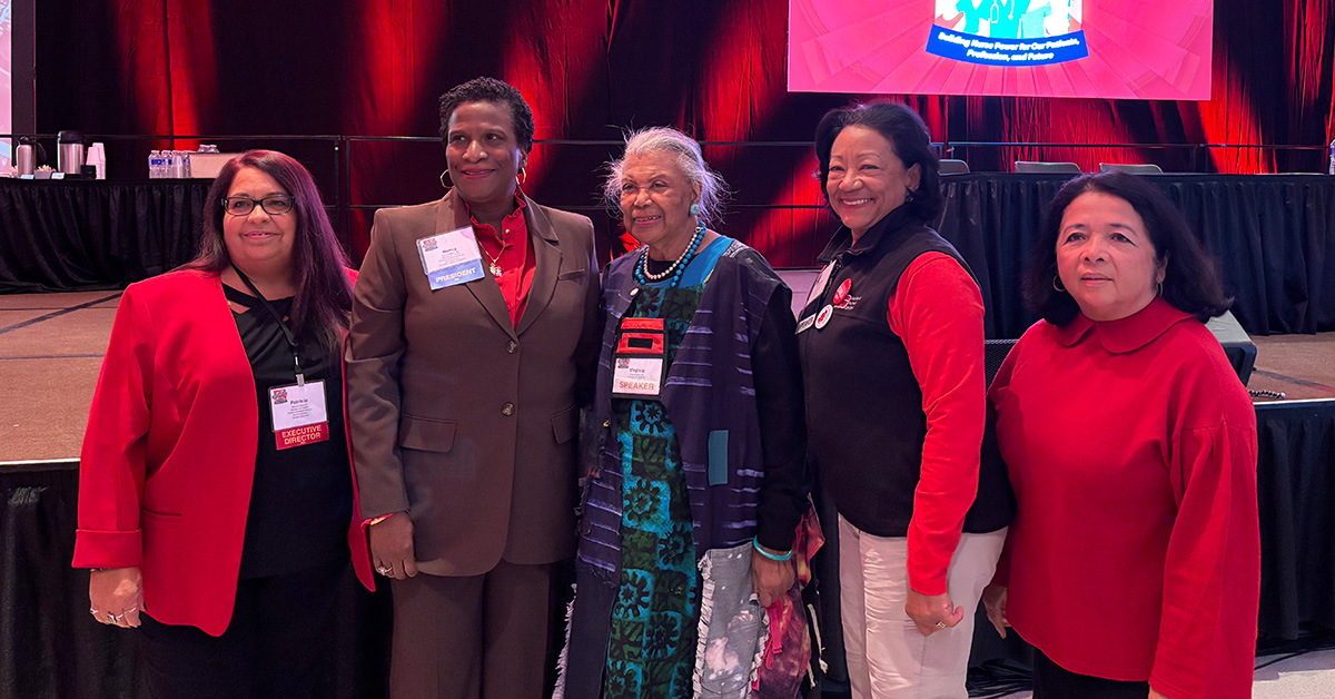 Virginia Allen standing with four NNU nurse leaders inside convention hall