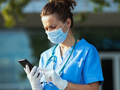 Nurse looking at smartphone