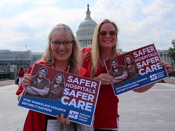 Nurses hold signs "Safer Hospitals, Safer Care"