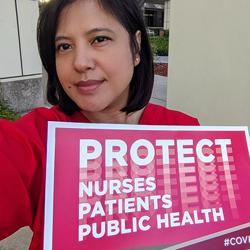 Mirasol Streams holding sign "Protect Nurses, Patients, Public Health"