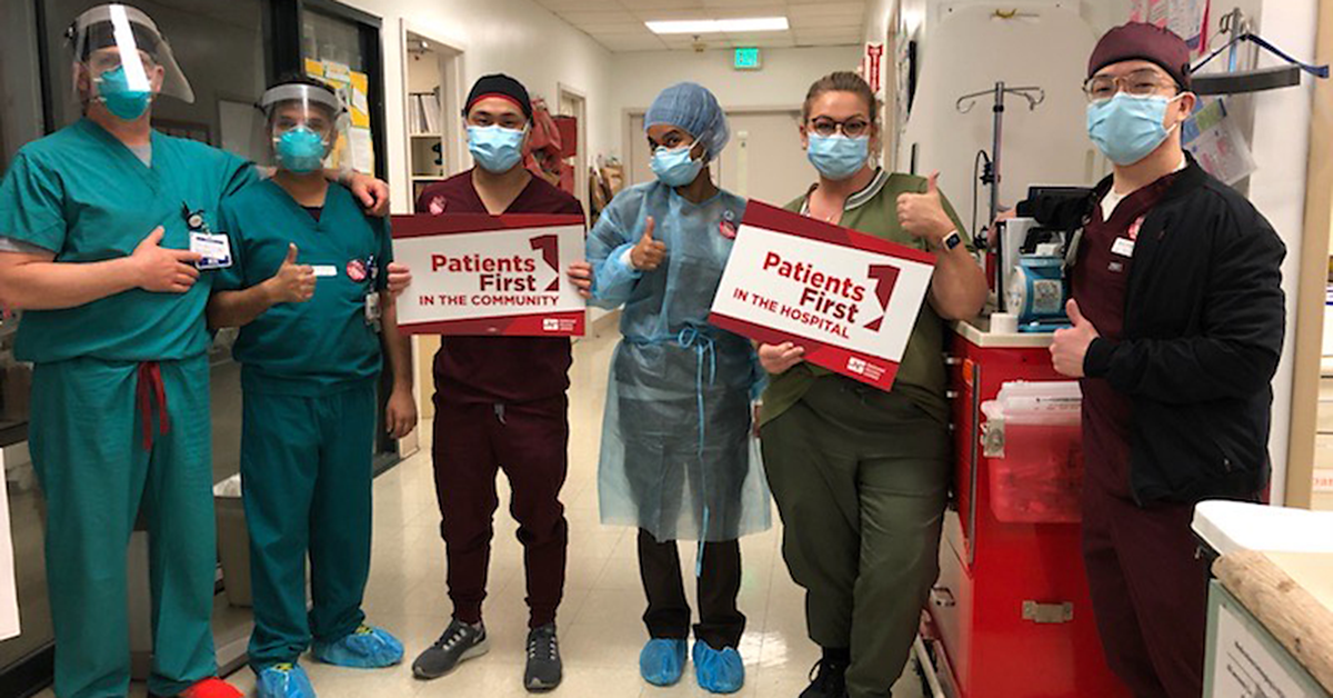 St. Rose nurses holding signs reading "Patients first in the community."