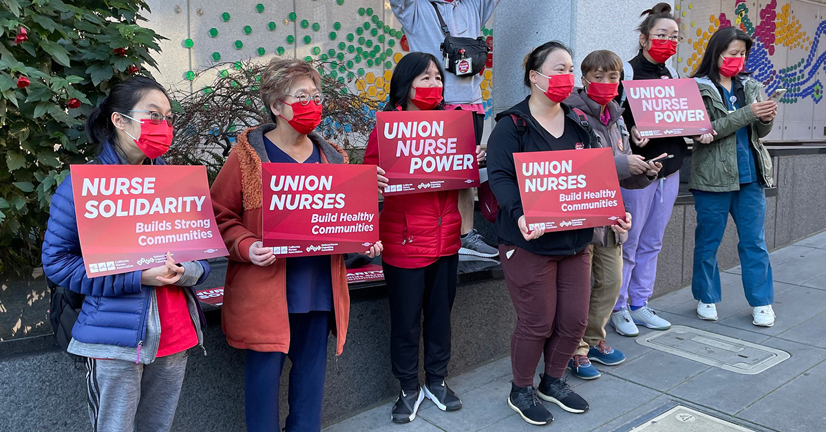 Nurses holding signs "Union Nurse Power"