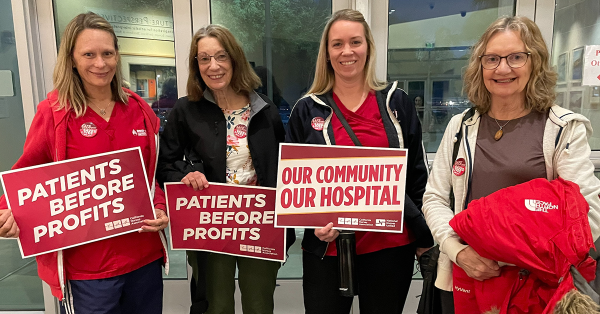 4 nurses from Desert Regional Medical Center holding signs "Patients before profits" and "Our community, our hospital"
