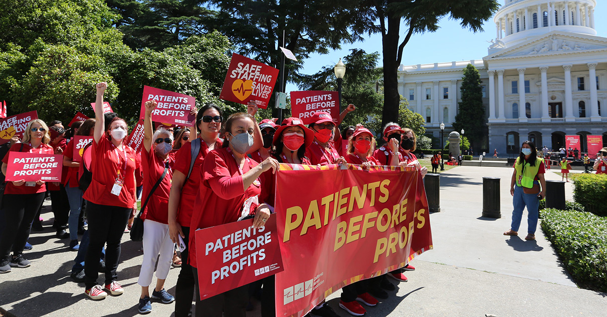 Nurses rally with signs that read "Patients over profits!"