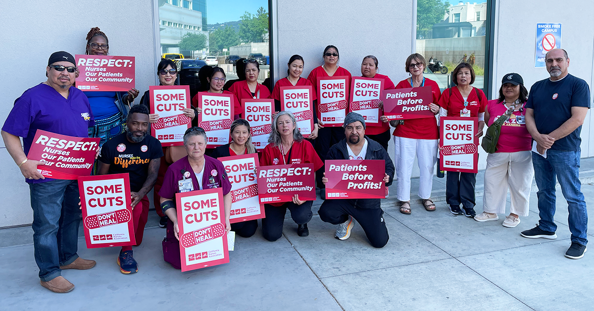 Alameda nurses in front of hospital with signs: "Some cuts don't heal" "Respect: Nurses, Our Patients, Our Community" "Patients before profits!"