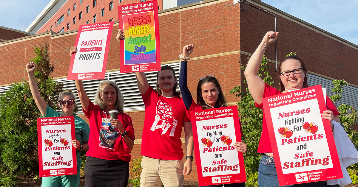 Five RNs at Mission Asheville holding signs "Nurses fighting for patients and safe staffing" "Mission nurses support safe staffing" "Patients over profits"