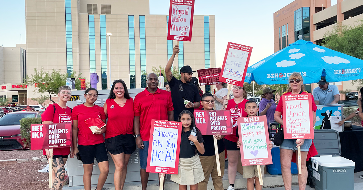 Nurses and their kids holding signs in front of hospital "Shame on you HCA!", "HCA, Put patients over profits!", "Proud union nurses!"