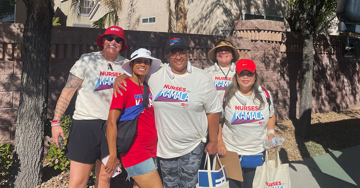 Group of five nurses outside, smiling, with canvassing materials and shirts "Nurses for Kamala"