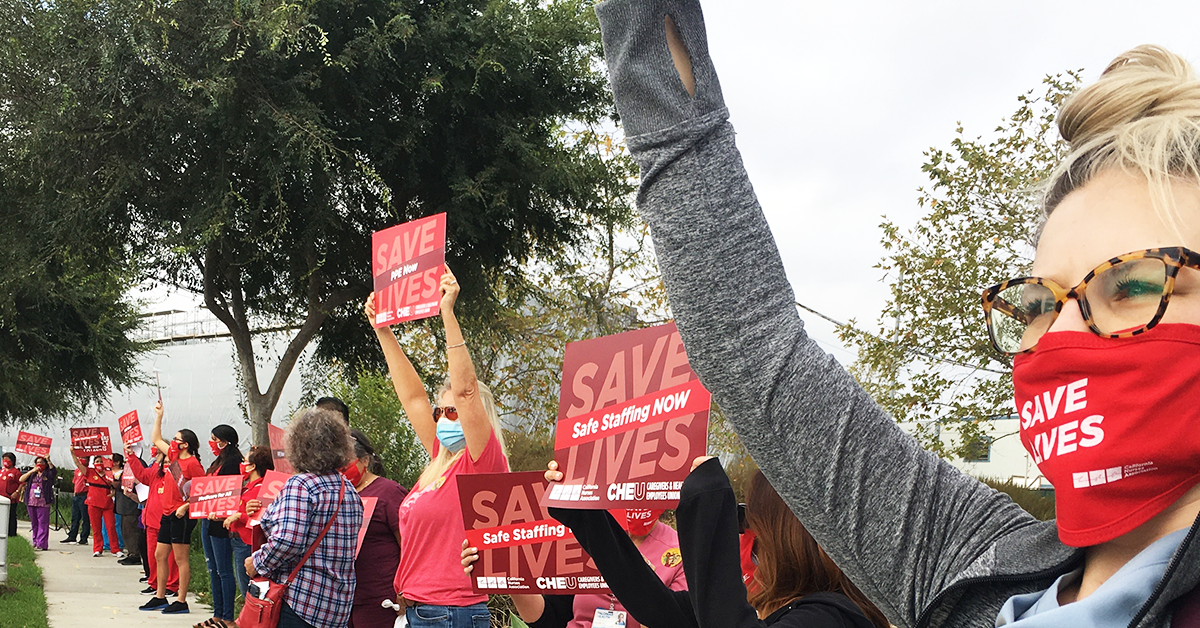 Members holding signs "Save lives: Safe staffing now"