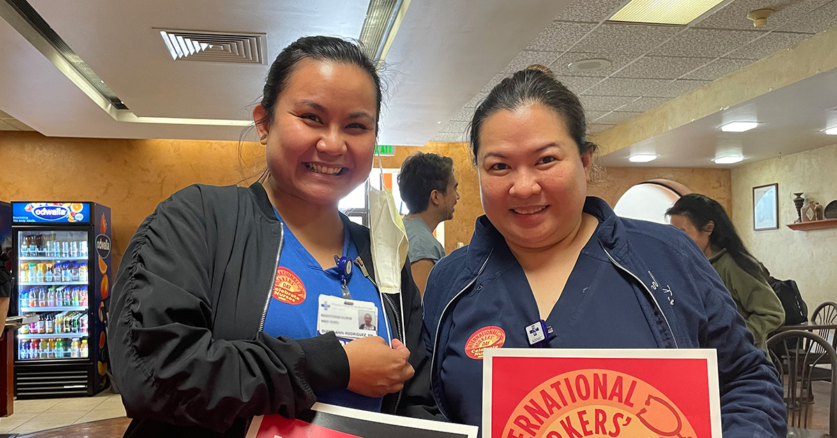 Two nurses smiling inside hospital