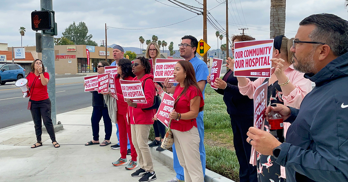 Nurses rallying outside of Hemet Global Medical Center, holding signs "Our Community, Our Hospital"