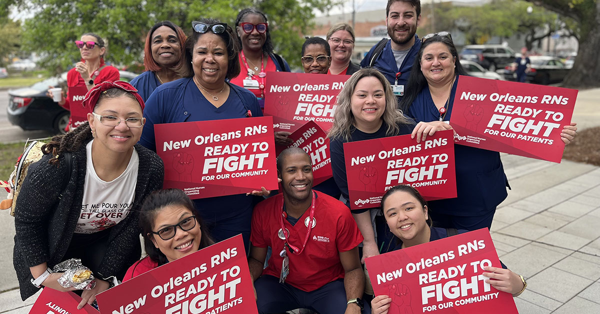 University Medical Center nurses pose with signs at info picket