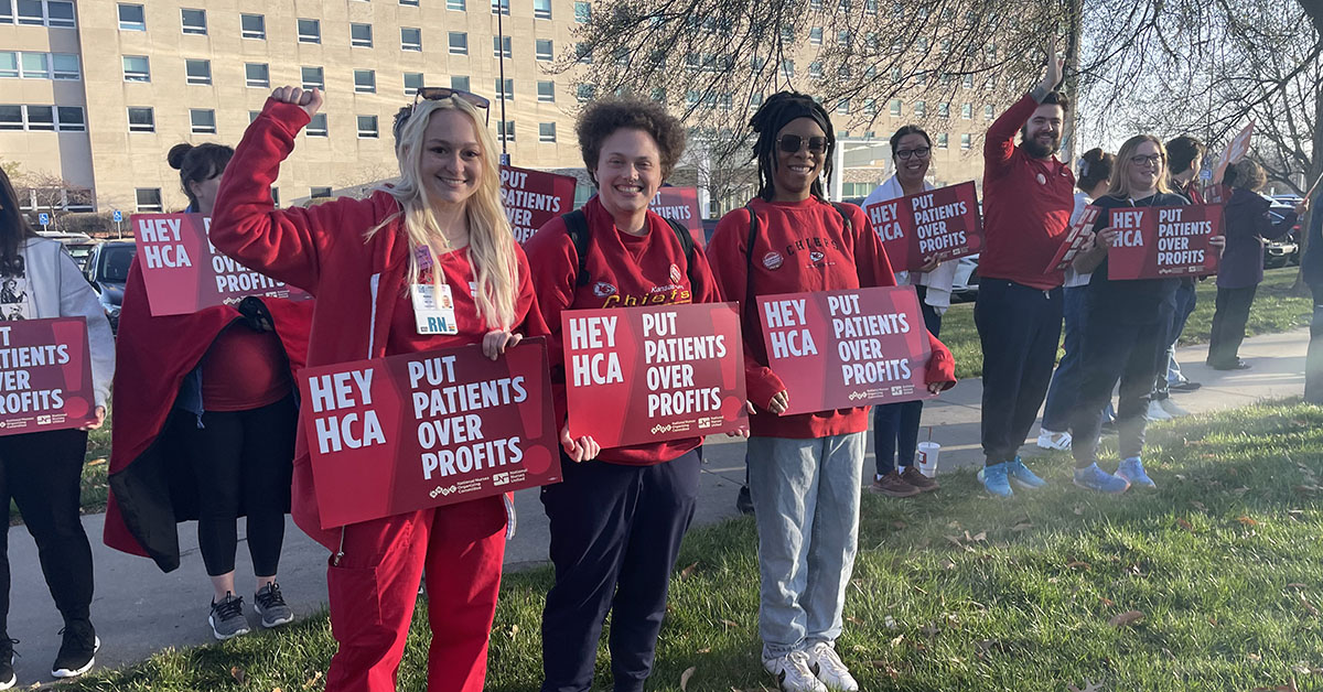 Kansas City nurses stand with signs that read "Put patients over profits."