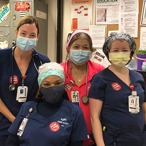 Group of four nurses inside hospital