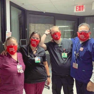 three nurses close together inside their workplace showing solidarity