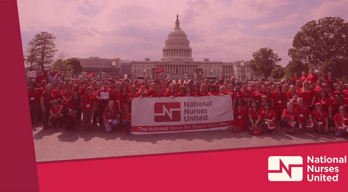 Large group of nurses outside Capitol building in Washington, D.C. with raised fists