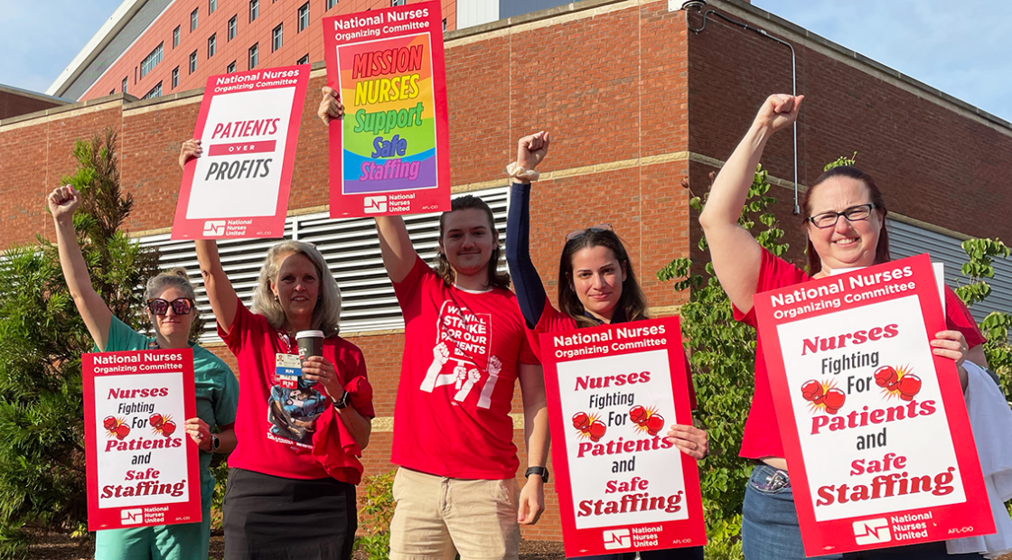 Five RNs at Mission Asheville holding signs "Nurses fighting for patients and safe staffing" "Mission nurses support safe staffing" "Patients over profits"