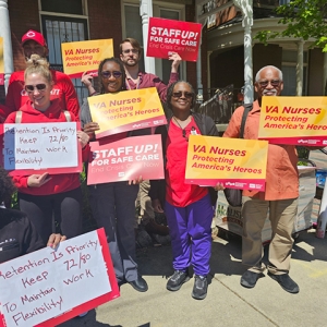 Nurses outside holding signs "VA Nurses: Protecting America's Heroes"