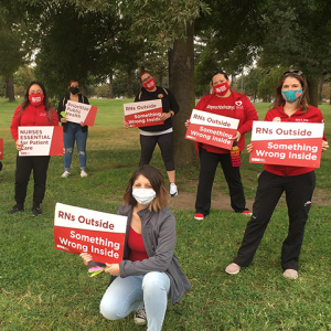San Joaquin County RN hold signs "RNs Outside, something wrong inside"