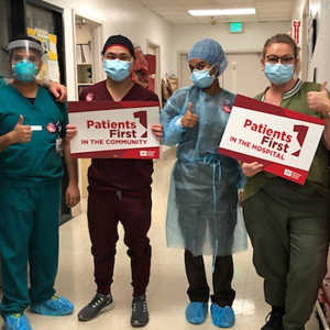 St. Rose nurses holding signs reading "Patients first in the community."