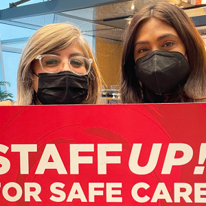 Nurses hold sign that reads "Staff up for safe care!"