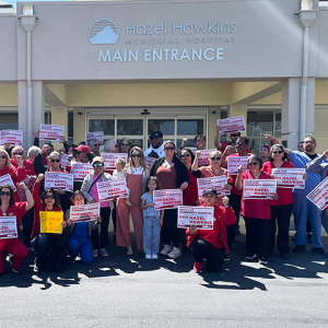 Hazel Hawkins RNs and community holding signs in front of hospital to "Save our community hospital. Save Hazel Hawkins."