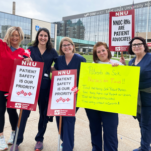 RNs outside Saint Louis University Hospital with signs "Patient safety is our priority" "NNOC RNs are patient advocates" "Patients are sick, nurses are tired..."