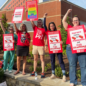 Five RNs at Mission Asheville holding signs "Nurses fighting for patients and safe staffing" "Mission nurses support safe staffing" "Patients over profits"