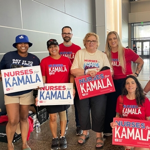 Group of canvassers holding signs "Nurses for Kamala"