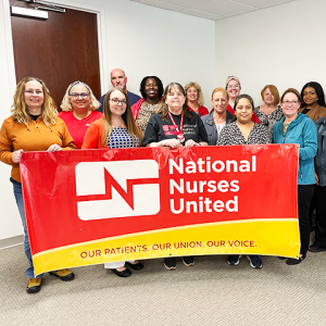 Tampa nurses holding banner "National Nurses United: Our Patients, Our Union, Our Voice"