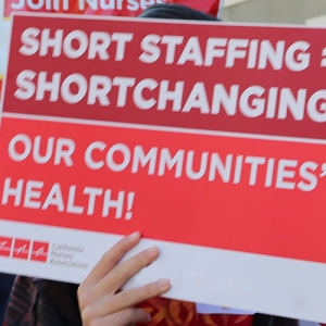 Health care workers with signs
