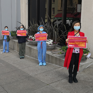 Nurses hold signs calling for patient safety outside Chinese Hospital