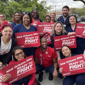 University Medical Center nurses pose with signs at info picket