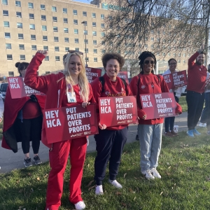 Kansas City nurses stand with signs that read "Put patients over profits."
