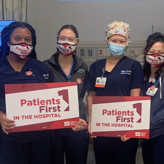 UCLA nurses hold signs that read "Patients first in the hospital."