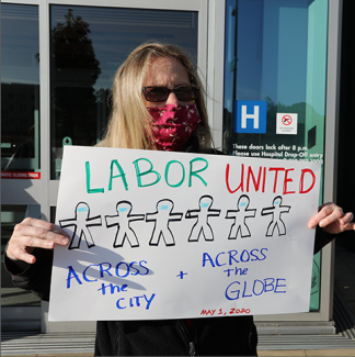 Nurse holds sign "Labor United"