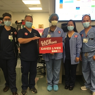 UCSF nursea hold sign "Safe Staffing Saves Lives"