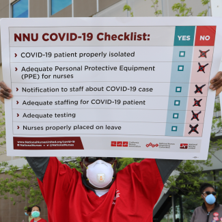 Nurse holds sign "NNU Covid-19 Checklist"