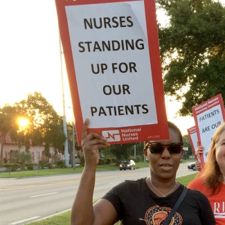 Nurse holding picket sign
